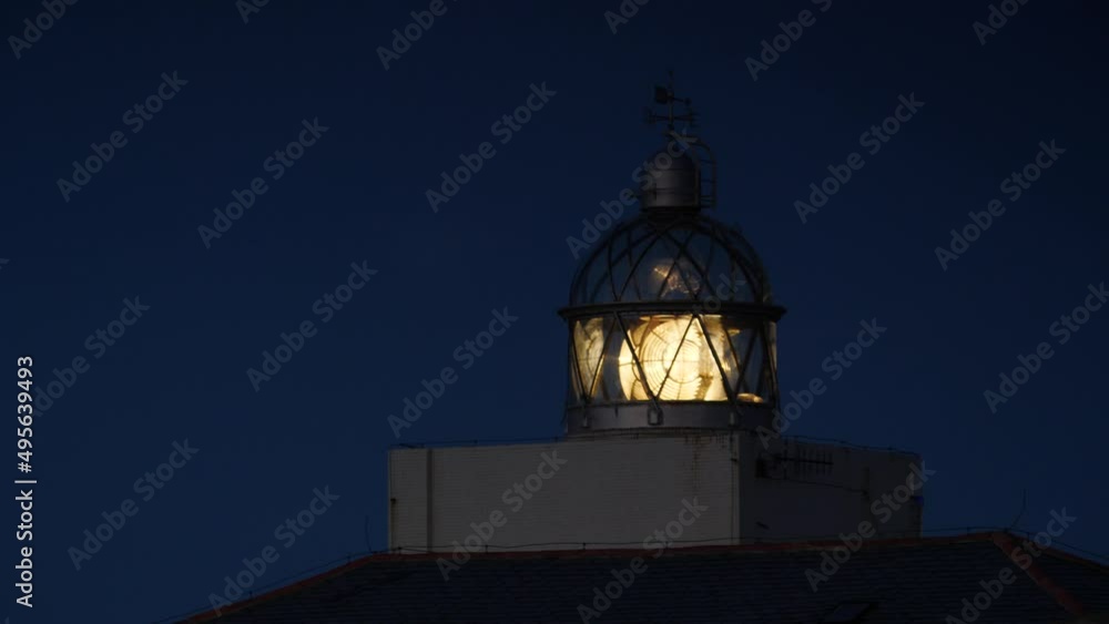Detail view. Lighthouse with beacon light in the night. Faro Cabo Busto on Asturias coast in Spain. Tourist attraction, place to visit. Detail view. Lighthouse with beacon light in the night. Faro Cabo Busto on Asturias coast in Spain. Tourist attraction, place to visit.