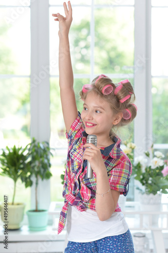 pretty girl with hair curlers with microphone