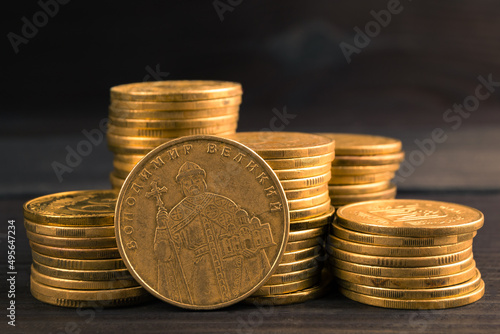 Ukrainian money. Ukrainian steel coin denominations of 1 hryvnia on dark background. Image of Great Volodymyr, Translate Volodymyr Velykyy on the obverse of the coin photo