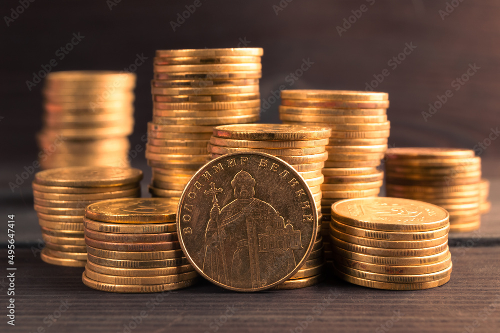 Ukrainian money. Ukrainian steel coin denominations of 1 hryvnia on dark background. Image of Great Volodymyr, Translate Volodymyr Velykyy on the obverse of the coin Ukrainian money. Ukrainian steel coin denominations of 1 hryvnia on dark background. Image of Great Volodymyr, Translate Volodymyr Velykyy on the obverse of the coin