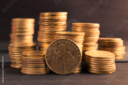 Ukrainian money. Ukrainian steel coin denominations of 1 hryvnia on dark background. Image of Great Volodymyr, Translate Volodymyr Velykyy on the obverse of the coin photo