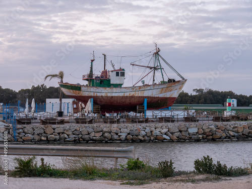 Rusty historic ship on the shore of Tabarca Island in Alicante, Spain photo