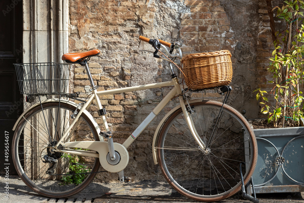 Vintage bicycle with basket resting on the streets of Rome in the Trastevere