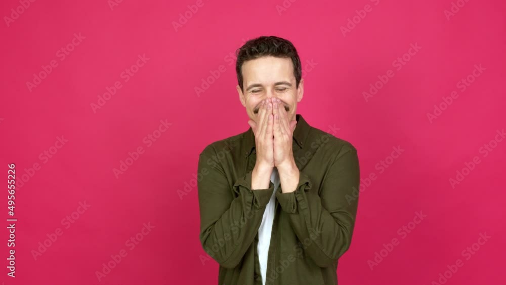 Man smiling a lot while covering mouth over isolated background Man smiling a lot while covering mouth over isolated background