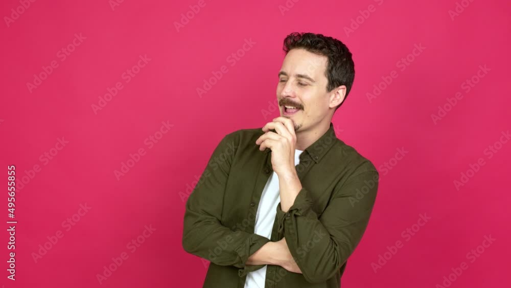 Man standing and looking to the side over isolated background Man standing and looking to the side over isolated background