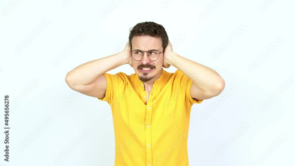 Man covering both ears with hands. Frustrated expression over isolated background Man covering both ears with hands. Frustrated expression over isolated background