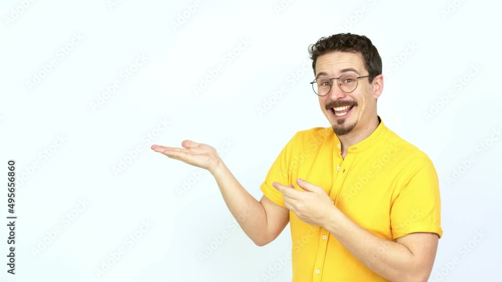 Man extending hands to the side and inviting to come over isolated background Man extending hands to the side and inviting to come over isolated background
