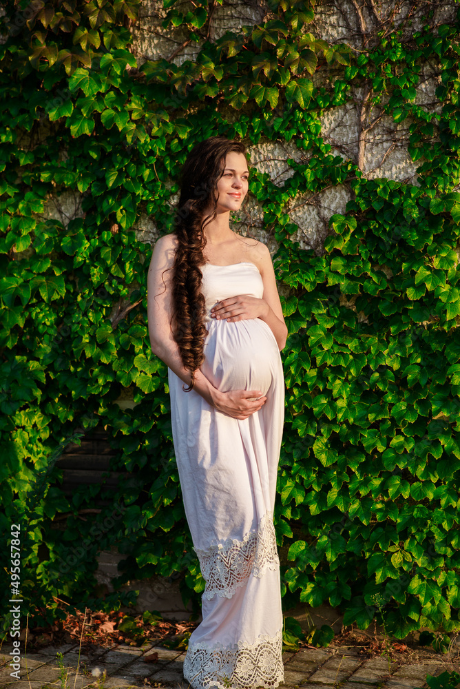 Young happy pregnant woman relaxing and enjoying life in nature. Outdoor shot. Copyspace Young happy pregnant woman relaxing and enjoying life in nature. Outdoor shot. Copyspace