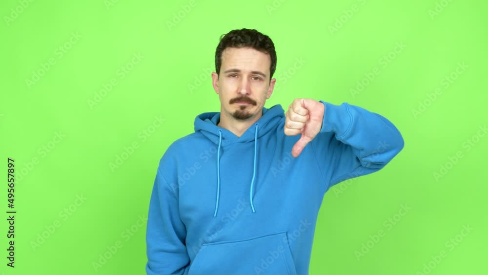 Man doing bad signal over isolated background. Green screen chroma key Man doing bad signal over isolated background. Green screen chroma key