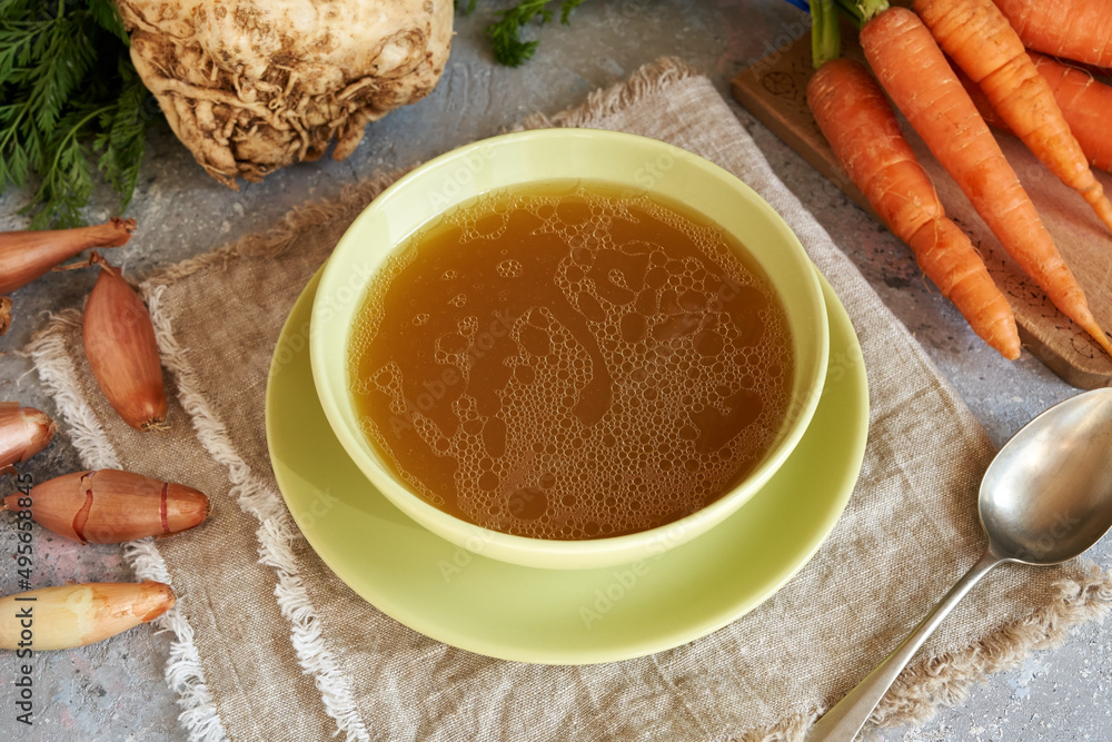 A bowl of beef bone broth on a table A bowl of beef bone broth on a table