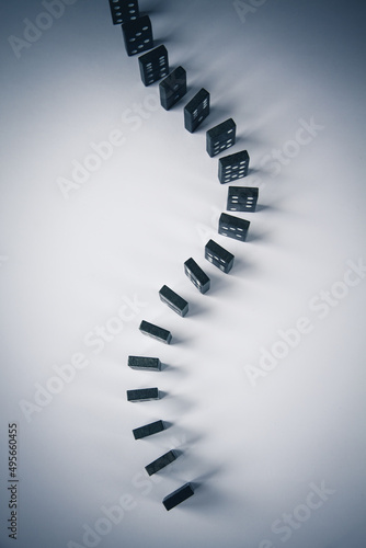 Black dominoes chain on white table background