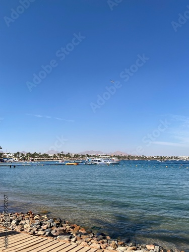 Beautiful beach coast in the Red Sea, Egypt. City and beach, Naama 'ama Bay. Egyptian hotel resort and spa view with blue sky