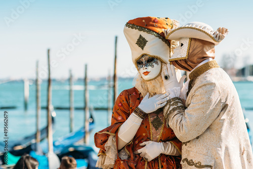 Venice Italy - February 28, 2022 - Masked people with a flamboyant costume posing for the carnival