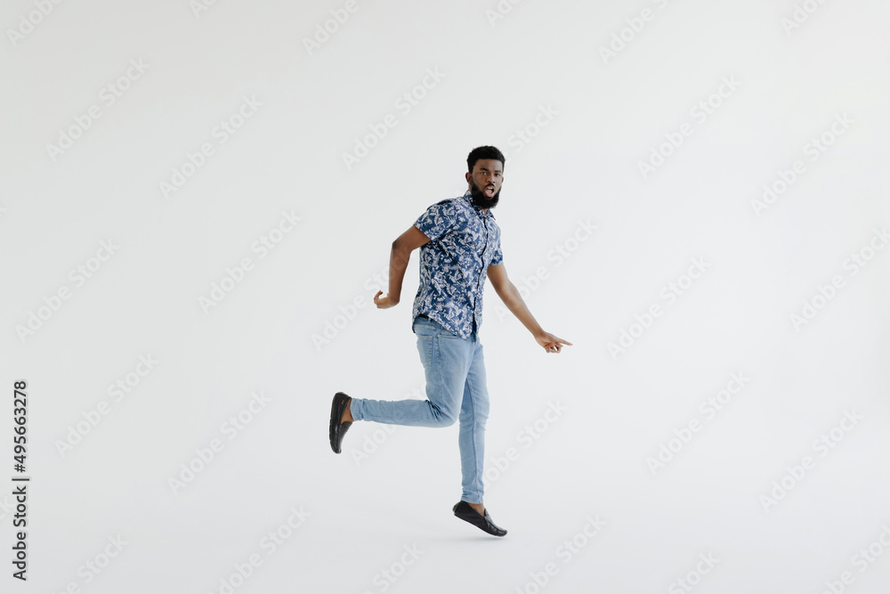 I did it. Full length of handsome young black man jumping against white background