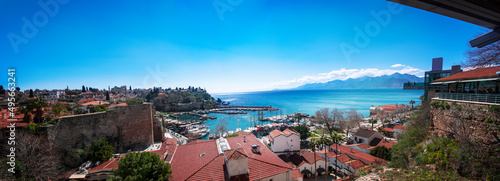 Fototapeta Naklejka Na Ścianę i Meble -  View of Antalya Old City Harbor, the Taurus Mountains and the spelling of the Mediterranean Sea	
