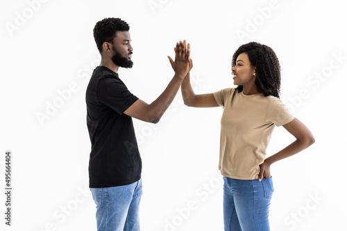 Portrait of a african couple giving high five isolated over white background