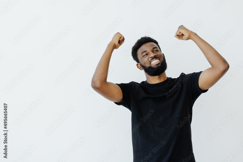 Naklejka premium Young African man isolated on white background raising fist after a victory, winner concept.
