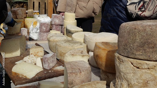 Cheese tasting. Artisan cheese at local market counter. Family-owned farm photo