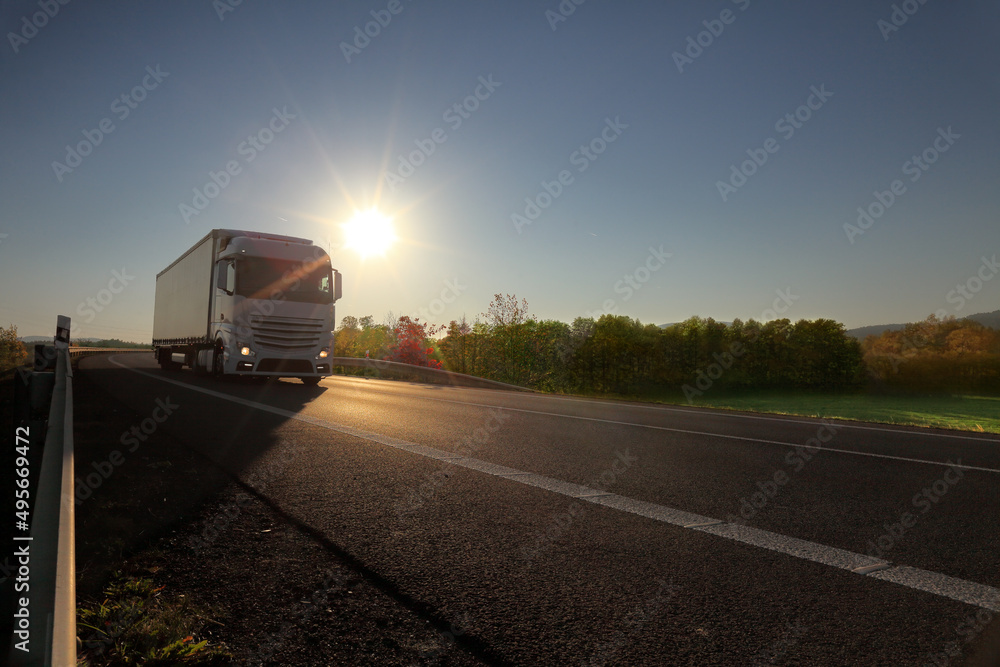 Landscape with a moving truck at sunset Landscape with a moving truck at sunset