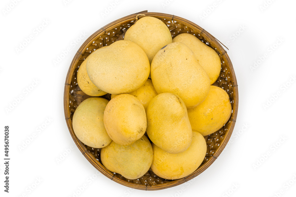 Mango tropical fruit in wooden basket on white background, top view. Mango tropical fruit in wooden basket on white background, top view.