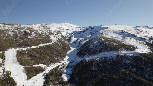 White snowy slopes down Sierra Nevada ski resort in Spain; aerial view