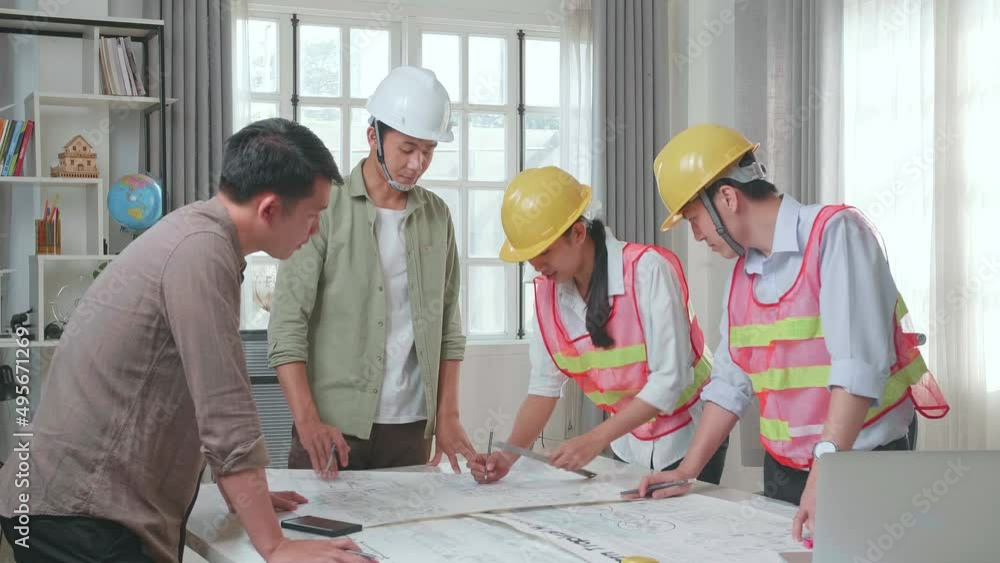 Three Asian Engineers With Helmets Helping A Man Drawing Building Construction At The Office
Three Asian Engineers With Helmets Helping A Man Drawing Building Construction At The Office