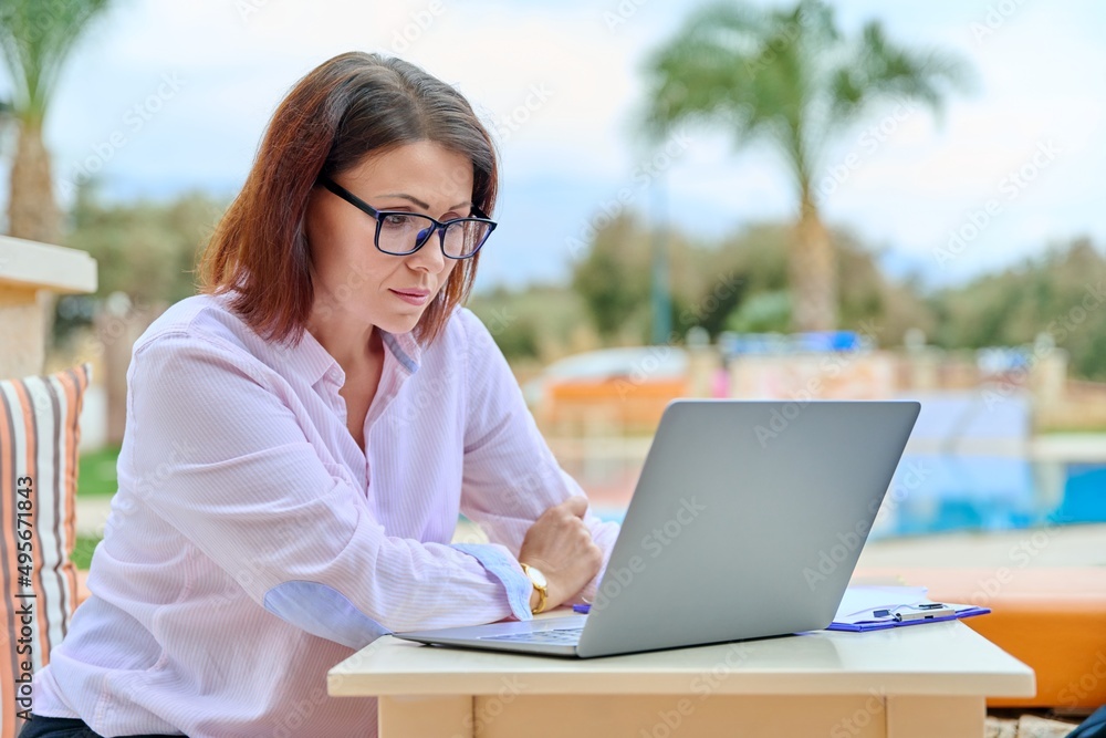 Beautiful business woman in her 40s working on a laptop remotely Beautiful business woman in her 40s working on a laptop remotely