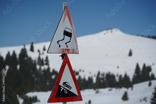 traffic sign. beware slippery road. photo during the day.