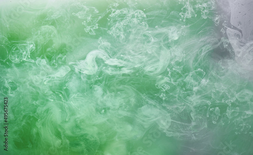 Green smoke on white ink background, colorful fog, abstract swirling emerald ocean sea, acrylic paint pigment underwater