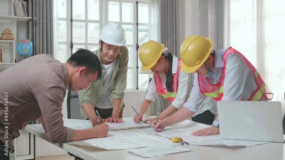 Three Asian Engineers With Helmets Helping A Man Drawing Building Construction At The Office
Three Asian Engineers With Helmets Helping A Man Drawing Building Construction At The Office