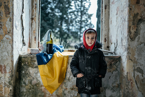 Little Boy in a Ruined House War in Ukraine Ukrainian flag