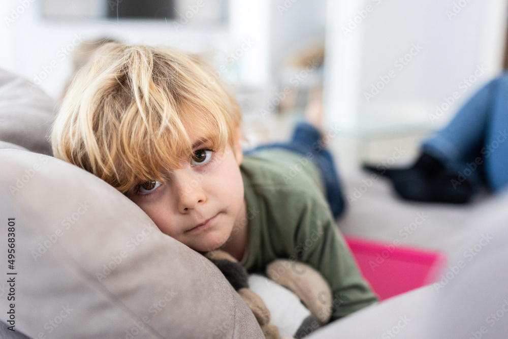 Sad boy lying on couch Sad boy lying on couch