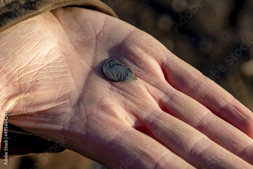 Closeup shot of Viking Age silver coin presented to fellow detectorists photo