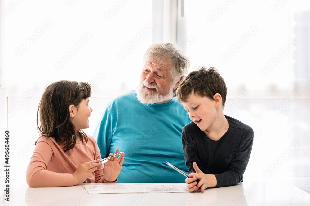 Grandfather teaching grandchildren to write Grandfather teaching grandchildren to write