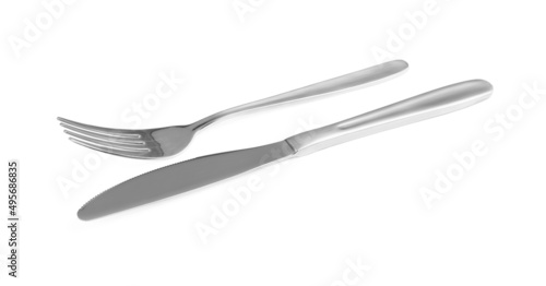 Shiny fork and knife on white background