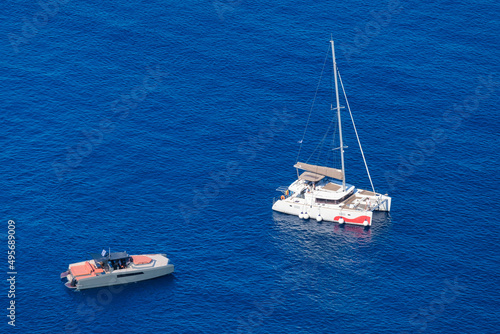Yacht on the water surface from top view. Turquoise water background from top view. Summer seascape from air. Travel concept and idea © biletskiyevgeniy.com