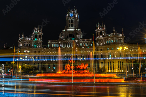Beautiful scene of Fuente de Cibeles building in Madrid, Spain at night with motion lights photo
