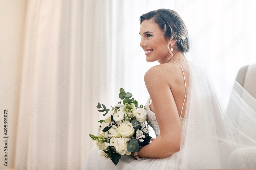 Radiantly beautiful on her wedding day. Cropped shot of an attractive young bride sitting alone in the dressing room and holding her bouquet of flowers. Radiantly beautiful on her wedding day. Cropped shot of an attractive young bride sitting alone in the dressing room and holding her bouquet of flowers.