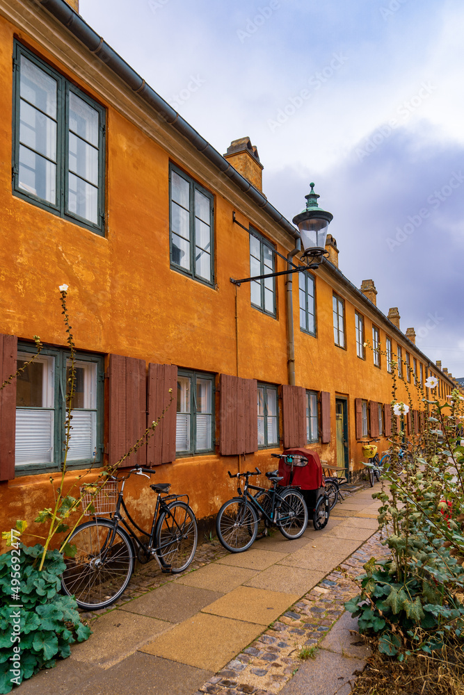 Copenaghen, Denmark - October 2, 2021: characteristic yellow terraced houses from the 17th and 18th centuries in the historic district of Nyboder in Copenhagen