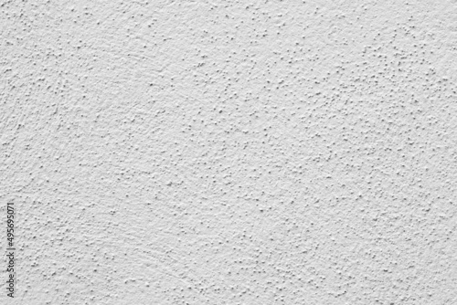 Painted wall with rough texture closeup. White plaster with brushed texture  house wall  copy space
