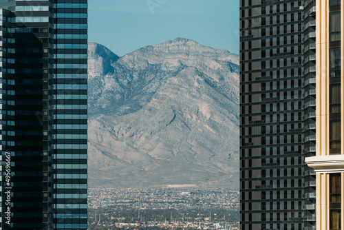 Photography Beautiful shot of a mountain from behind a high skyscrapers in Las Vegas, Nevada