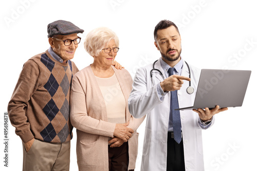 Elderly man and woman and a doctor pointing at a laptop computer