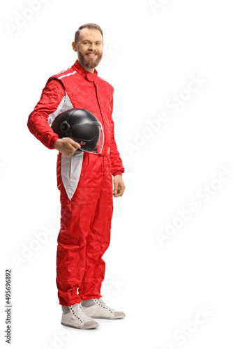 Full length shot of a car racer holding a helmet and smiling
