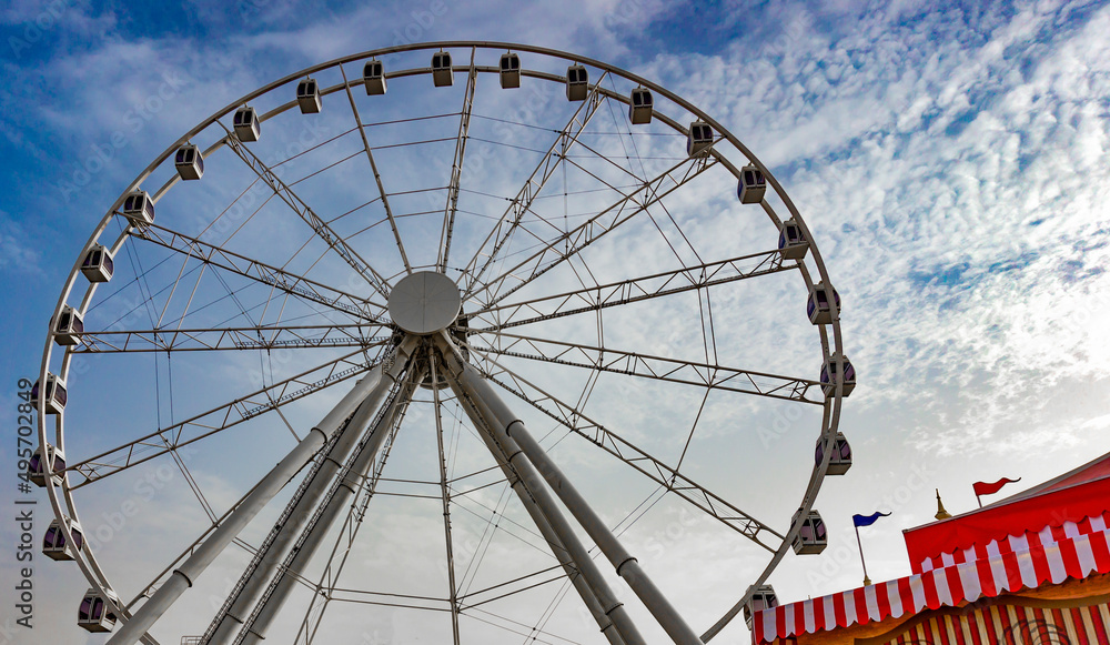 Big wheel at a fair festival with blue sky