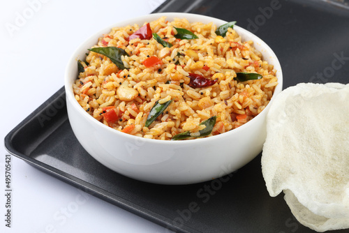 Tomato rice. spicy South Indian rice cooked rice with Tomato and HERBS Tomato pulao, an Indian vegetarian dish. Healthy nutritious tomato rice