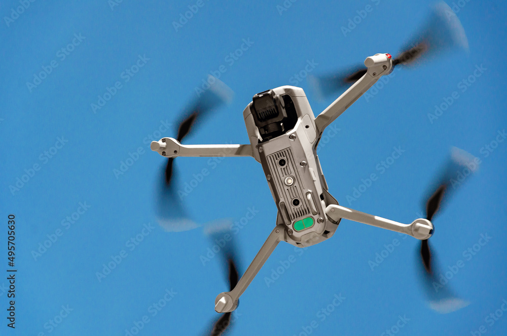 Drone flying in the air. Bottom view. Blue sky background. New technologies. Drone flying in the air. Bottom view. Blue sky background. New technologies.