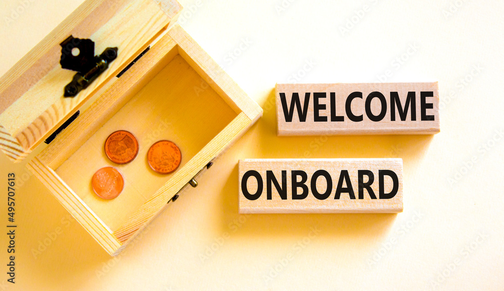 Welcome onboard symbol. Concept words Welcome onboard on wooden blocks on a beautiful white table white background. Wooden chest with coins. Business onboarding and welcome onboard concept copy space. Welcome onboard symbol. Concept words Welcome onboard on wooden blocks on a beautiful white table white background. Wooden chest with coins. Business onboarding and welcome onboard concept copy space.