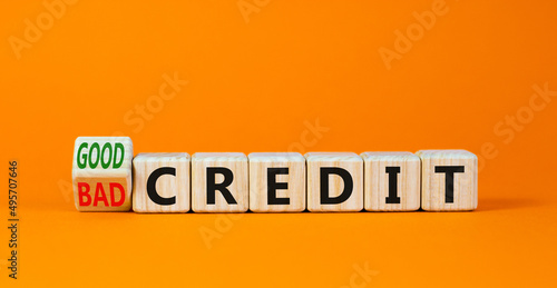 Good or bad credit symbol. Turned wooden cubes and changed concept words Bad credit to Good credit. Beautiful orange table orange background, copy space. Business good or bad credit concept.