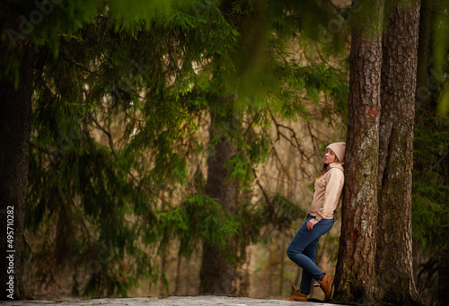 young girl in a pine forest on a frosty day