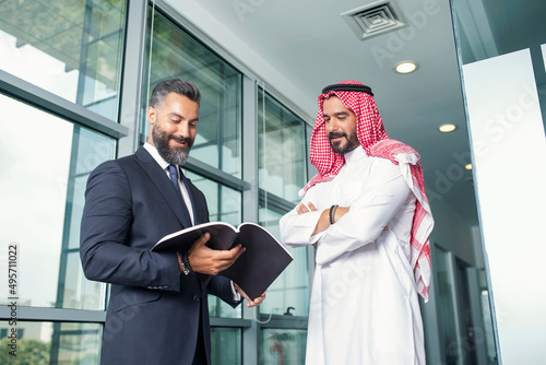 Arabian Businessman with a foreign businessman discussing work in a modern office  photo